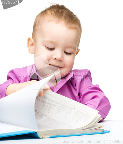 Image of Cute little child play with book