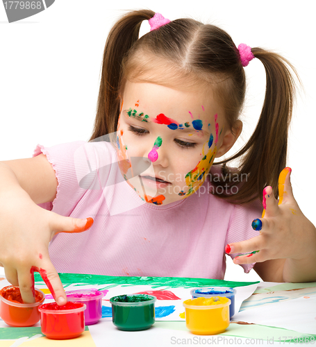 Image of Cute cheerful child play with paints