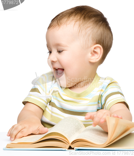 Image of Cute little child play with book