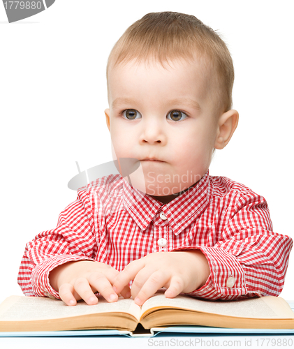 Image of Cute little child play with book