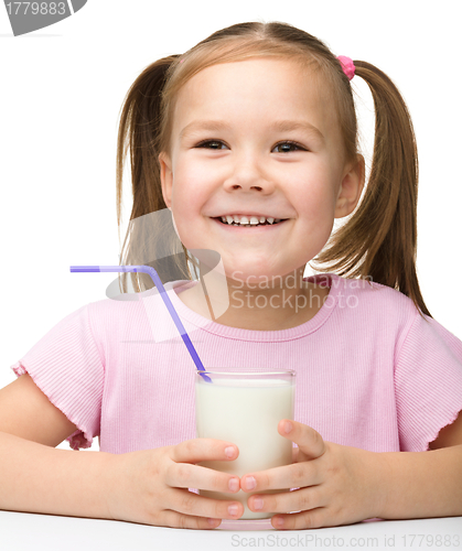 Image of Cute little girl with a glass of milk