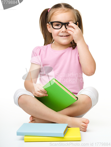 Image of Cute little girl with books