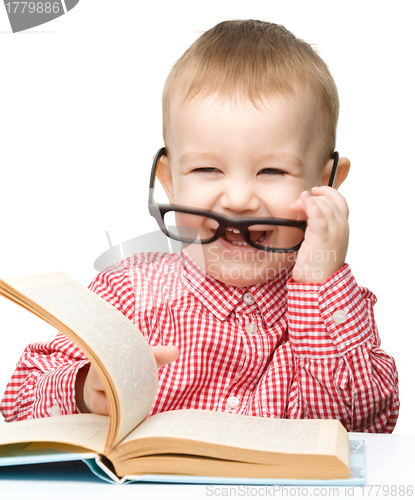 Image of Cute little child play with book