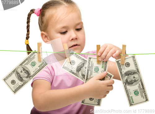 Image of Cute little girl with paper money