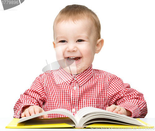 Image of Cute little child play with book