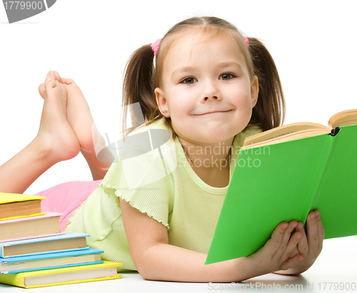 Image of Cute little girl reads a book