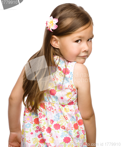 Image of Little girl is looking back over her shoulder