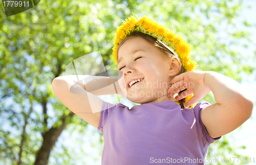 Image of Portrait of a little girl with dandelion wreath