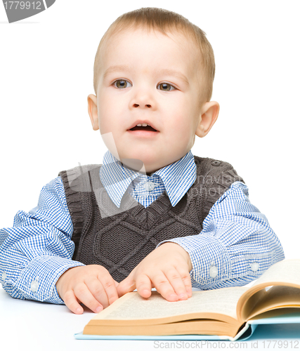 Image of Portrait of a cute little boy with books