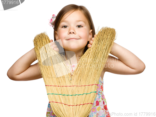 Image of Portrait of a little girl with broom