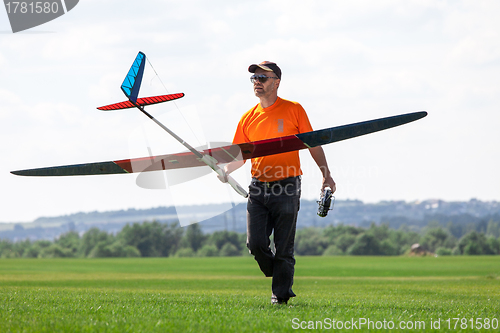 Image of Man holds the RC glider