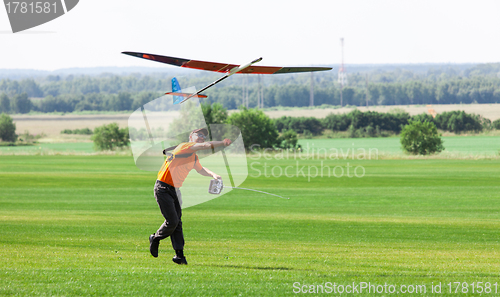 Image of Man launches into the sky RC glider