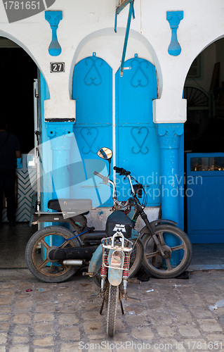 Image of Decorative traditional Tunisian door, with moped