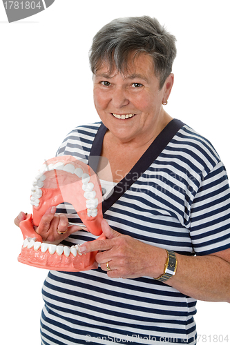 Image of Senior woman pointing on tooth