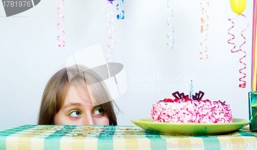 Image of Holiday. A girl looks out from under the table