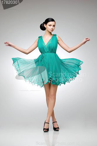 Image of brunette in teal dress