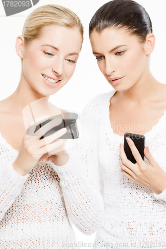 Image of two young women with smartphones