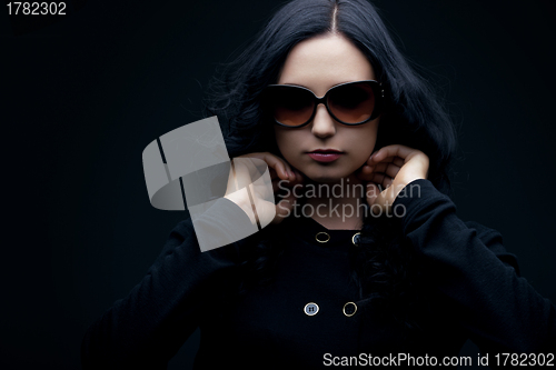 Image of brunette wearing sunglasses