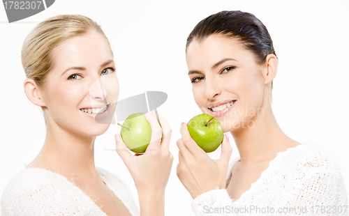 Image of two smiling women with apples