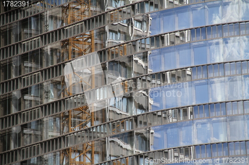 Image of Construction site reflected in a house