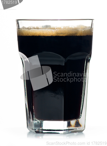 Image of Beer glass full of cold black irish stout.