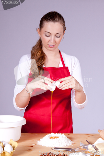 Image of beautiful woman is baking cookies for christmas