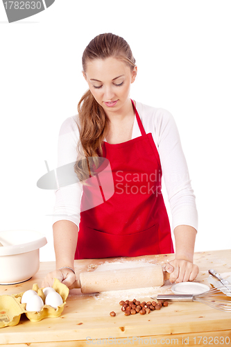 Image of beautiful woman is baking cookies for christmas