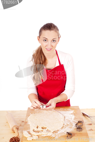 Image of beautiful woman is baking cookies for christmas