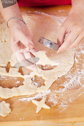Image of beautiful woman is baking cookies for christmas