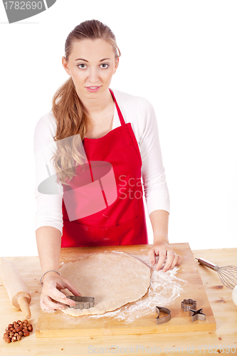 Image of beautiful woman is baking cookies for christmas