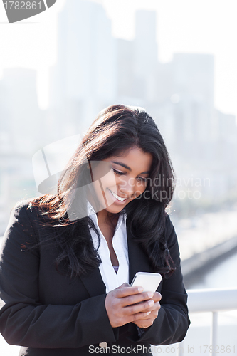 Image of Indian businesswoman texting on the phone