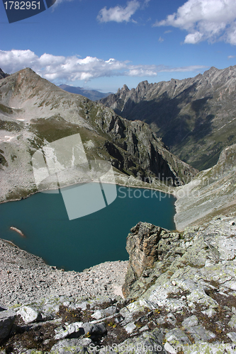 Image of Lake in mountains. Alpine latitudes at different times of the ye