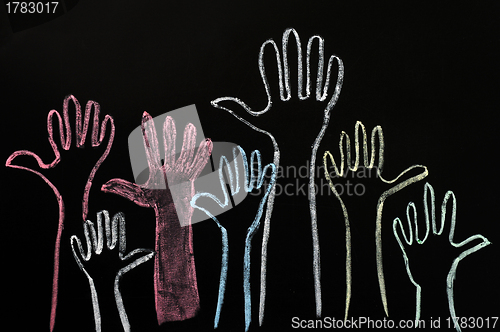 Image of Happy volunteering hands on a blackboard background