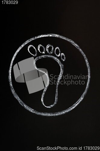 Image of Chalk drawing of footprint symbol on blackboard background