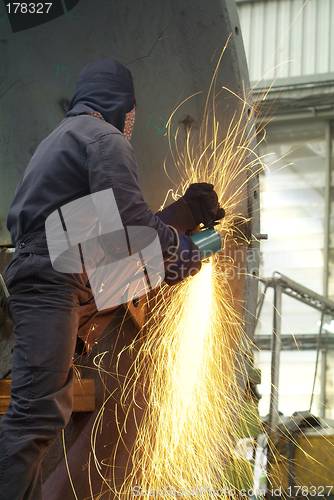 Image of Man working with angle grinder
