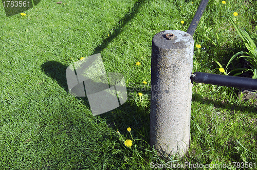 Image of Closeup of concrete fence pole and shadows meadow 