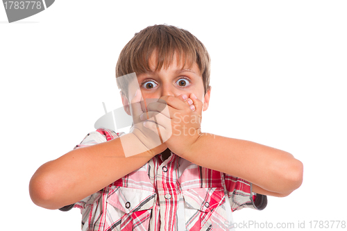 Image of Boy covering his mouth and looking very shocked 