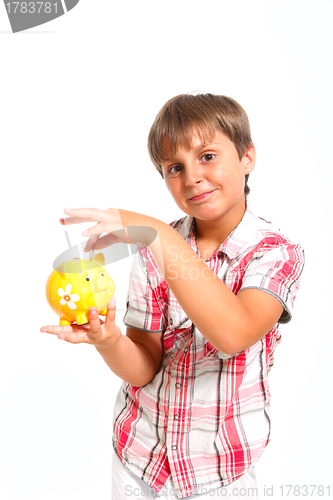Image of boy puts the coin into the piggy bank isolated on white 