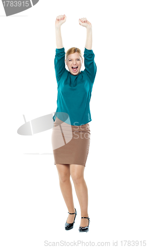 Image of Joyful corporate woman posing with raised arms