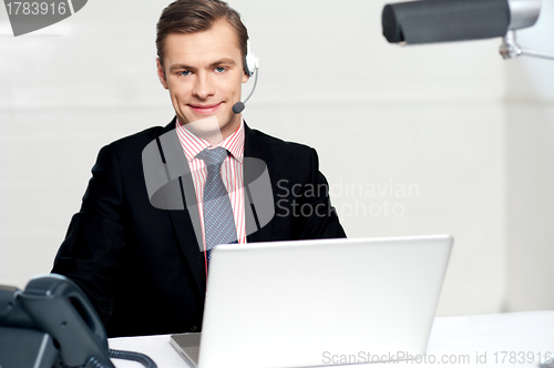 Image of Call centre executive posing with headsets