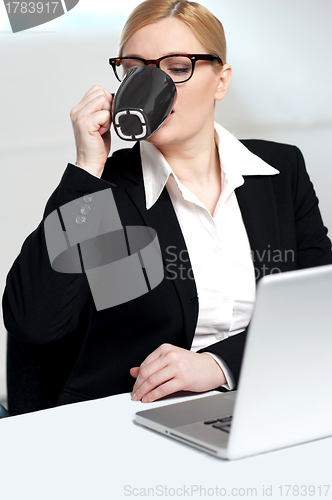 Image of Corporate lady drinking coffee