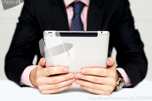 Image of Businessman's hands holding portable device