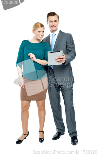 Image of Businessman using tablet pc with secretary beside