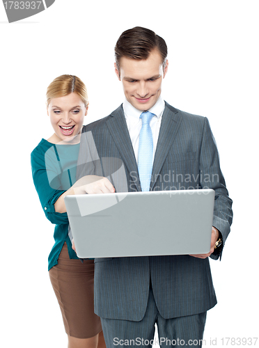 Image of Smiling business people using laptop