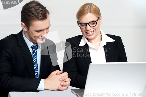 Image of Colleagues working together on laptop