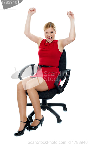 Image of Excited woman sitting in chair. Isolated