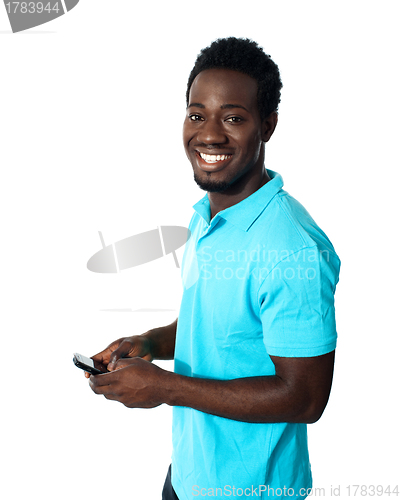 Image of Handsome african man using cellphone