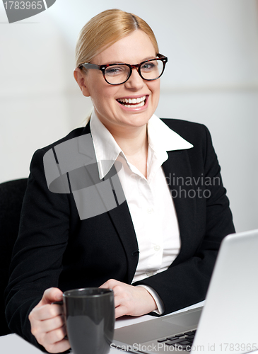 Image of Beautiful businesswoman holding coffee cup