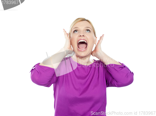 Image of Woman shouting with hands on ears