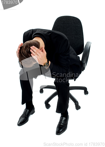 Image of Frustrated young man sitting on chair